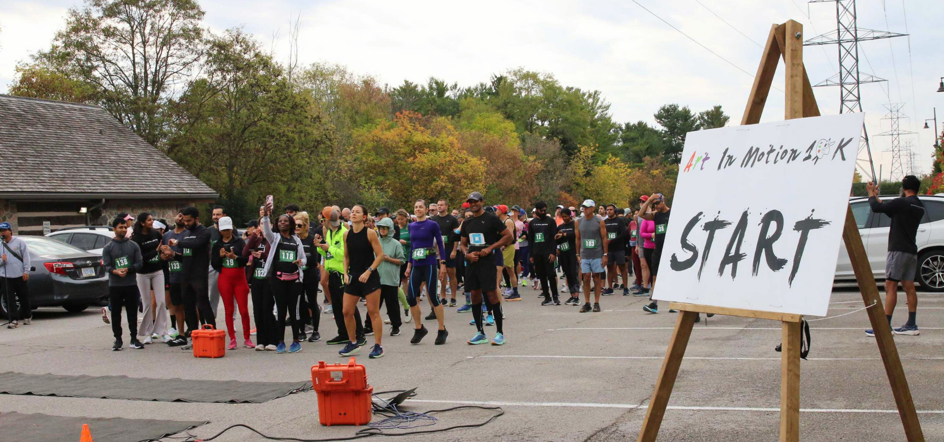 Runners gathered beside the start sign for the Art In Motion 10K/5K/2K Charity Run at Boyd Conservation Area in Vaughan.

