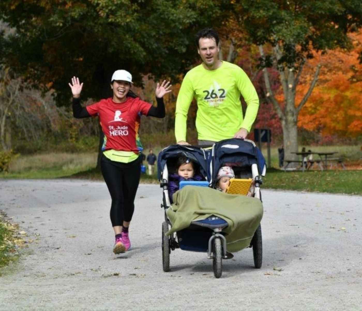 Family running with children in a stroller during the Art In Motion 2K Family Run and Walk