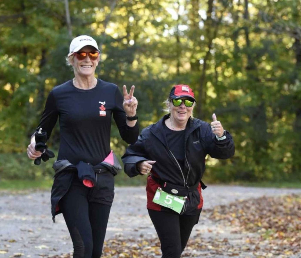 Runners smiling during the Art In Motion 5K at Boyd Conservation Area